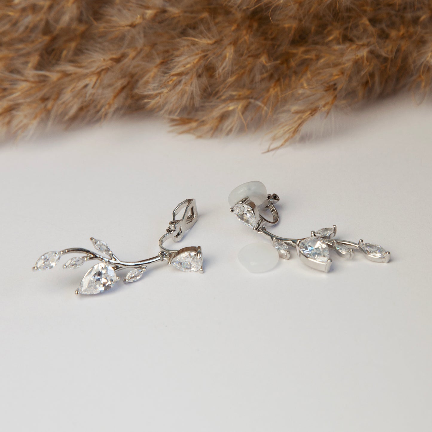 Clip On Diamond Earrings, Mini-Clip Dangle Earrings, Non-Pierced Plant Bridal Wedding Earrings
Our Mini-Clip Dangle Earrings are the perfect choice for those seeking subtle elegance or with small earlobes. Enjoy stylish charm and comfort in a compact design.