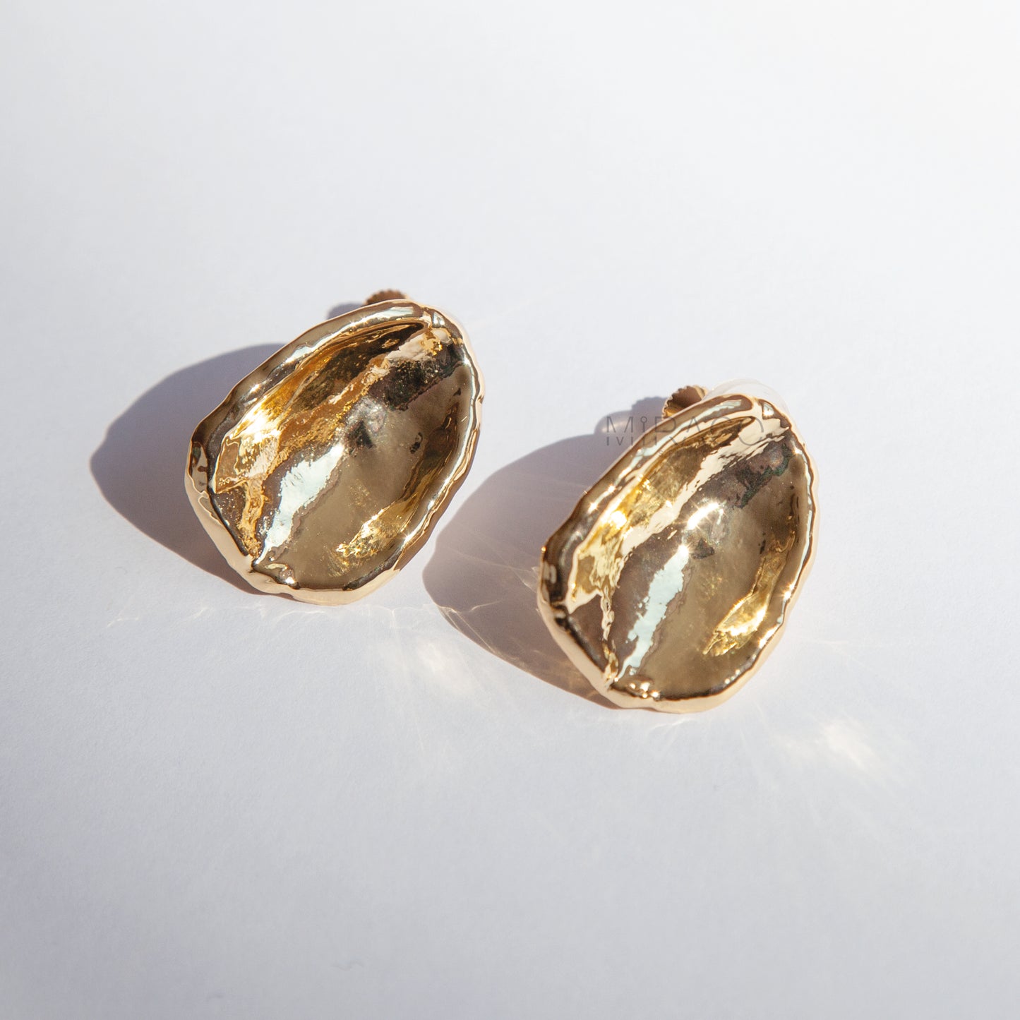Effortless Elegance, No Piercing Needed.
Make a sophisticated statement without needing pierced ears! These stunning clip-on earrings feature a captivating, organically inspired shape with a beautifully textured surface. Finished in a radiant gold plating, they catch the light exquisitely, adding a touch of modern luxury to any look.
Designed for both style and comfort, these earrings utilize a secure screw-back clip mechanism. This allows you to adjust the tension for a perfect, personalized fit that sta
