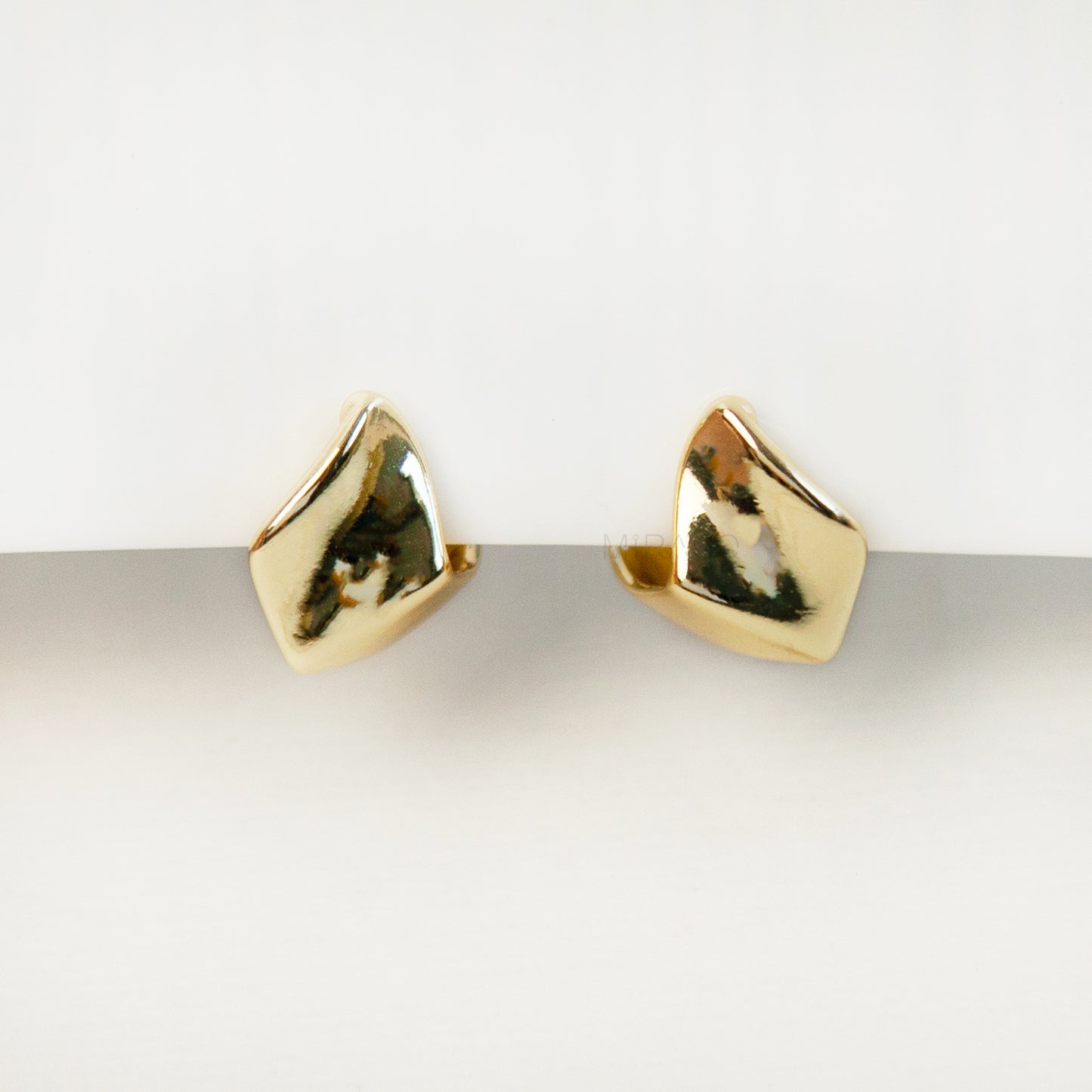 Gold geometric clip-on stud earrings with coil-back clips, minimal modern design for non-pierced ears.