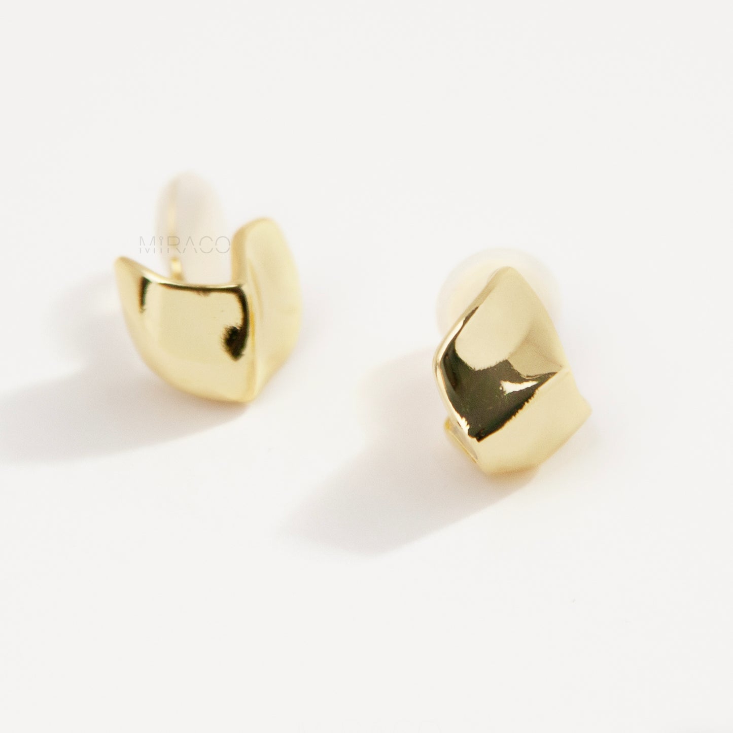 Gold geometric clip-on stud earrings with coil-back clips, minimal modern design for non-pierced ears.