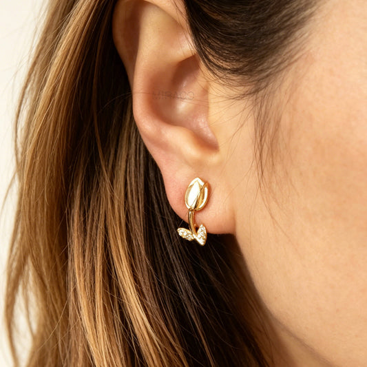 gold tulip flower clip-on earrings for non-pierced ears featuring soft white cat-eye stone petals and small sparkling crystal leaves