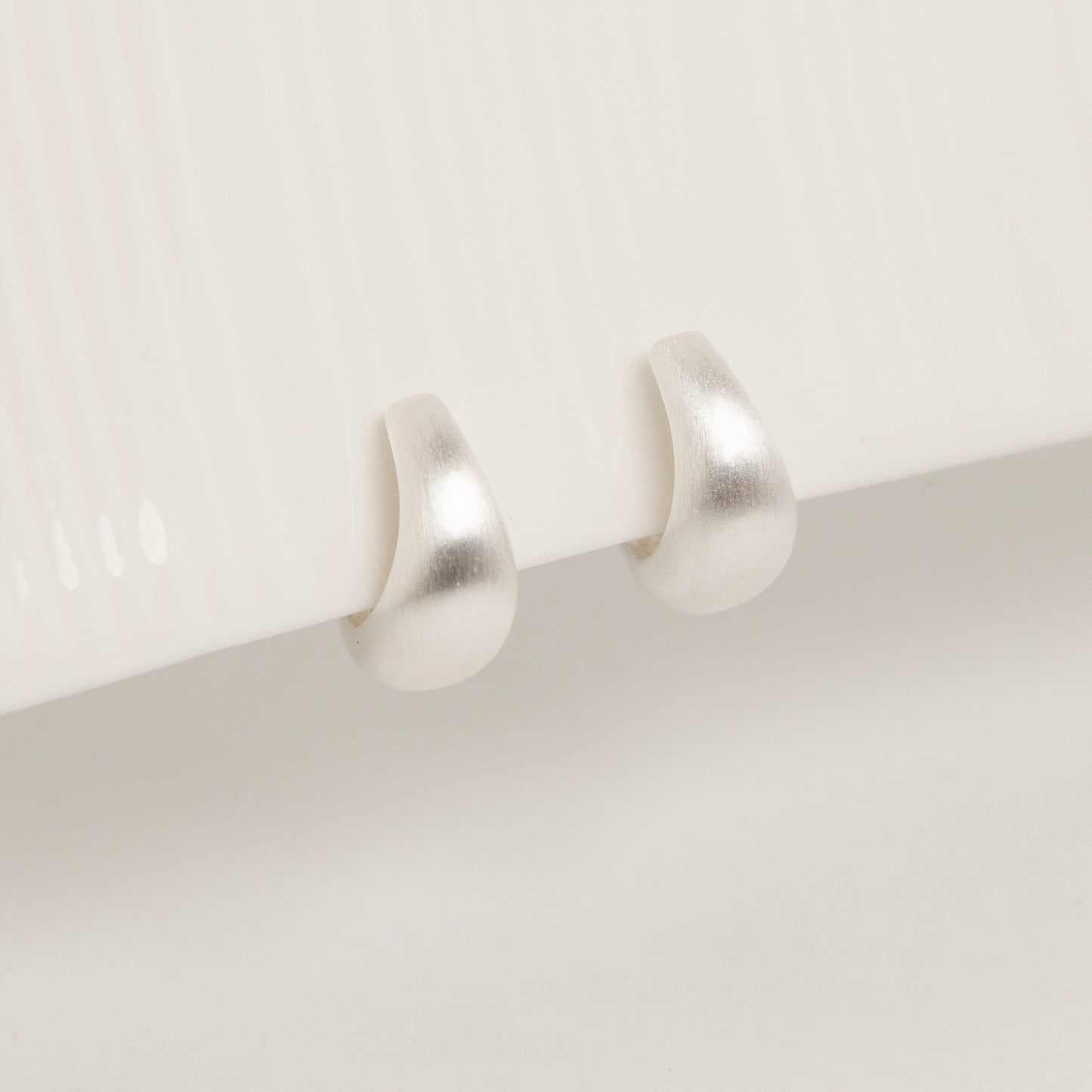 brushed silver clip-on earrings, dome hoop clip-ons, silver coil back earrings, non pierced hoop earrings, matte silver hoop earrings, clip-on everyday earrings, brushed finish earrings, classic silver dome hoops