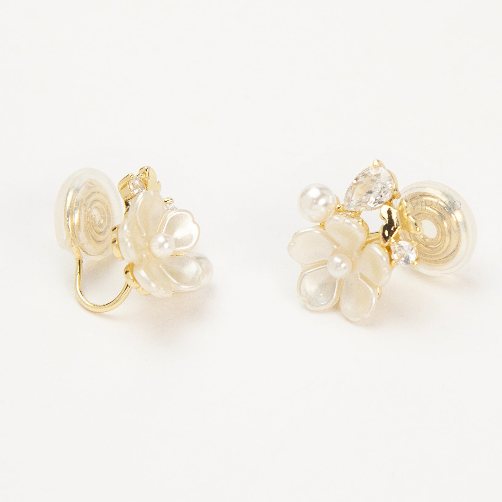 Gold-tone pearl flower clip-on earrings with crystals and coil-back clips for non-pierced ears.