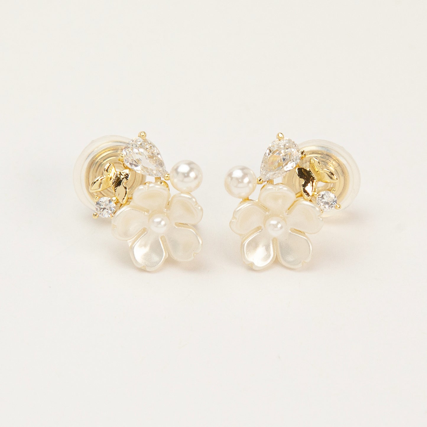 Gold-tone pearl flower clip-on earrings with crystals and coil-back clips for non-pierced ears.