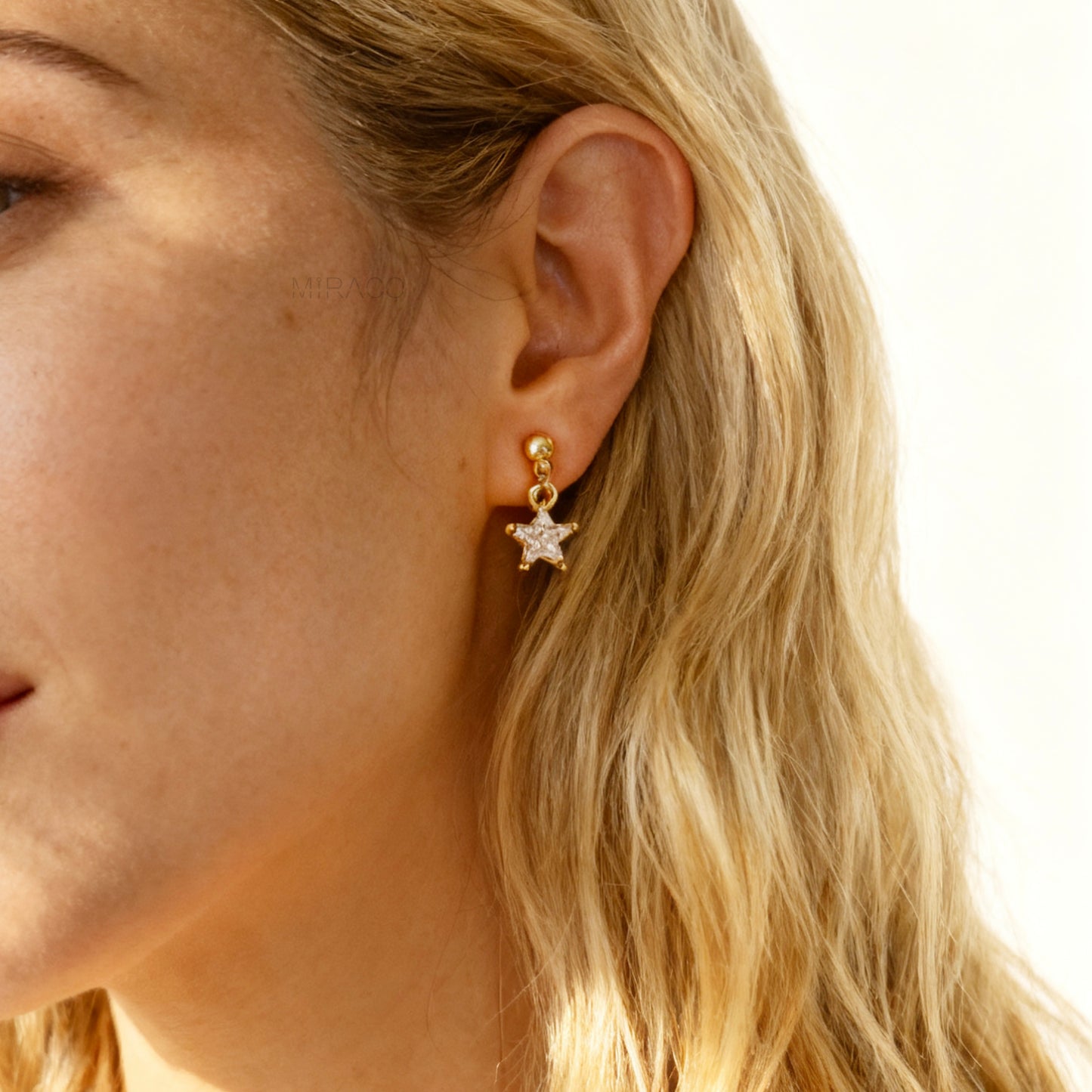 Gold moon and star mismatched clip-on earrings with crystal dangles, non-pierced coil back design