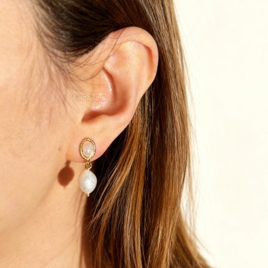 Pair of gold-tone, coil-back clip-on earrings with an oval, bezel-set iridescent opal-effect stone and a dangling real, irregularly shaped baroque freshwater pearl.