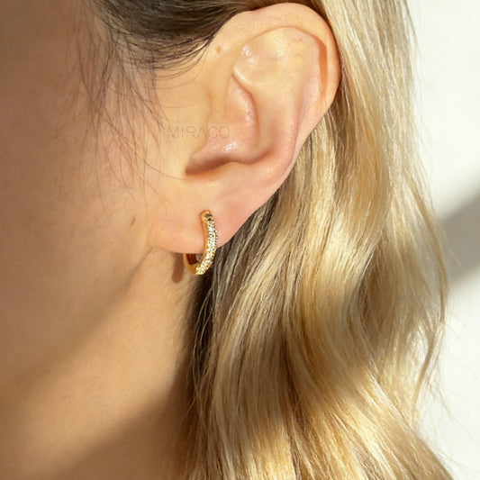 Gold clip-on hoop earrings with sparkling pave diamonds and coil back clips