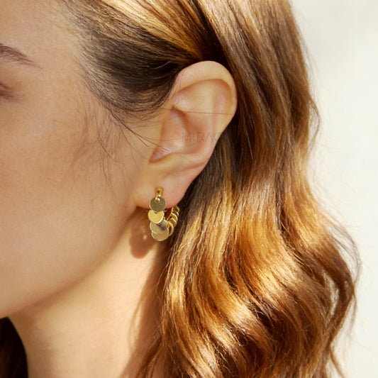 Gold U-shaped clip-on earrings with dangling coin charms and comfortable coil back design for non-pierced ears