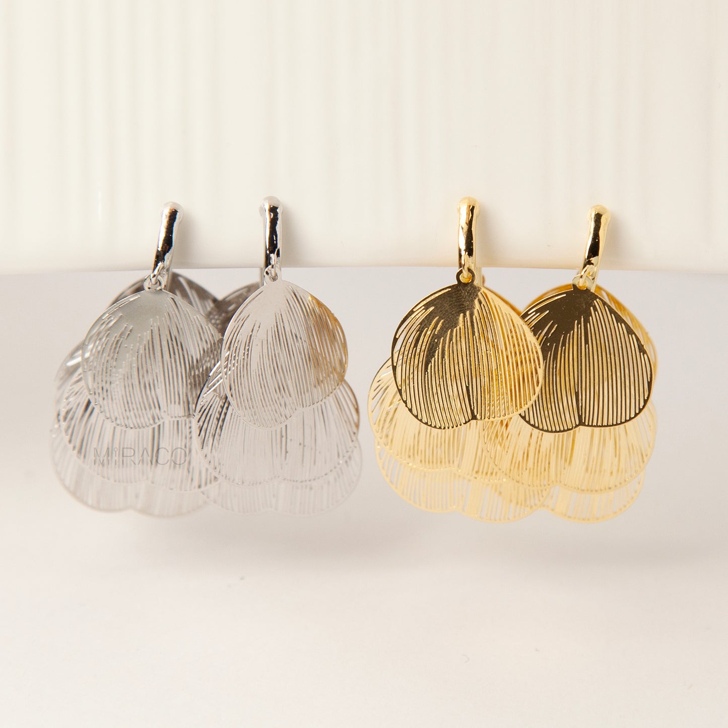 Gold and silver layered petal clip-on earrings with textured fan-shaped charms and comfortable coil back for non-pierced ears