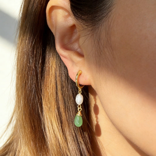 Gold clip-on earrings with freshwater pearl and green drop charm, featuring a comfortable coil back for non-pierced ears