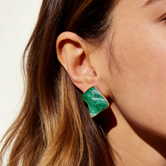 Pair of square-shaped emerald green marbled enamel clip-on earrings with gold-tone edges and comfortable coil back closures.