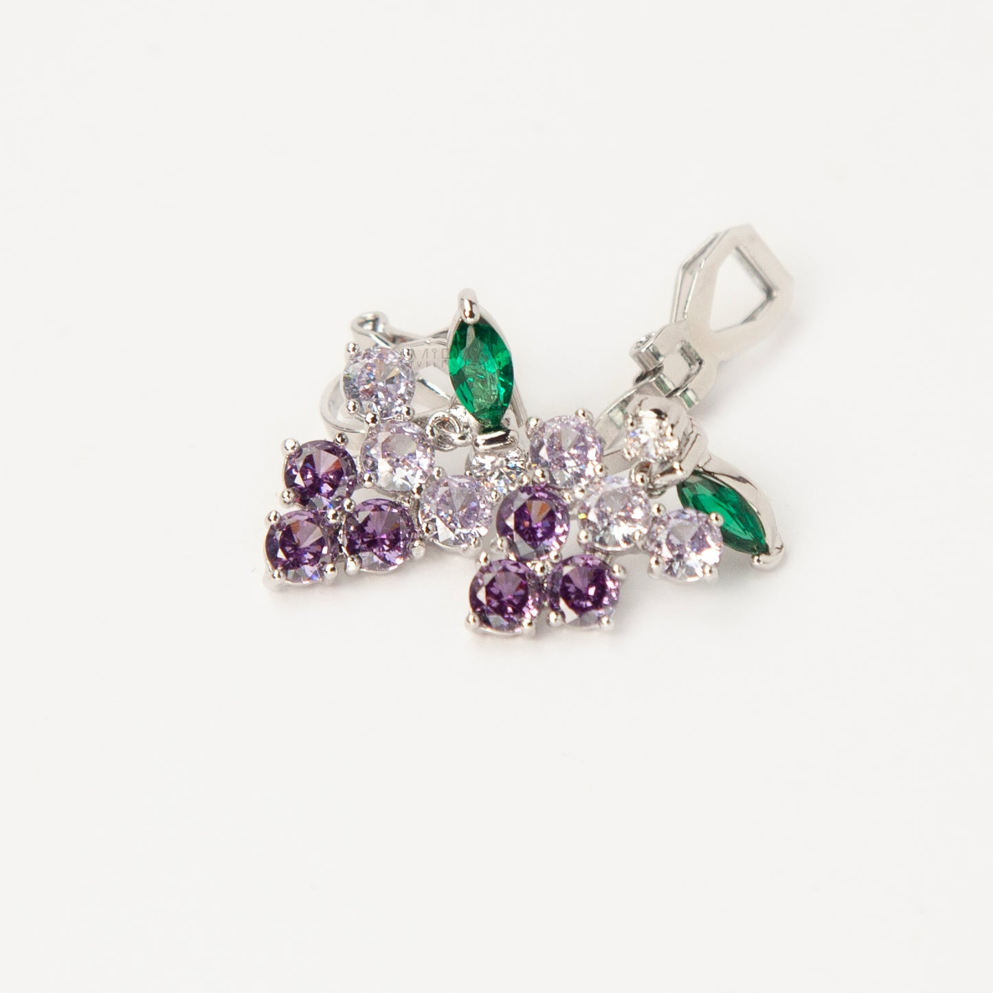 A pair of silver-tone clip-on earrings in the shape of a grape cluster, featuring various shades of round purple crystals and a green marquise-cut crystal leaf