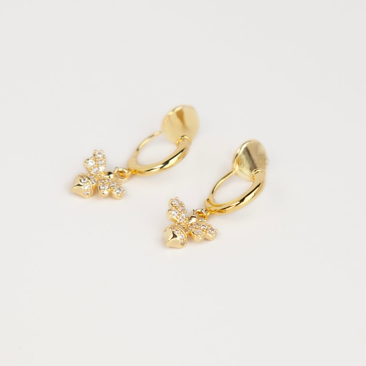 Gold clip-on hoop earrings with a sparkling cubic zirconia pave bumblebee charm and comfortable round cushion backings.