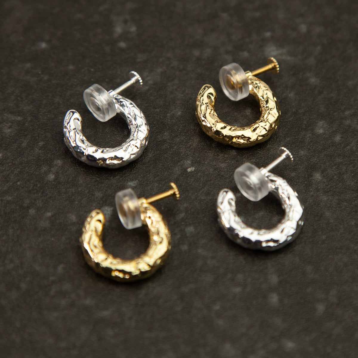 Gold and silver textured molten chunky hoop clip-on earrings with adjustable screw back closures and silicone comfort pads.