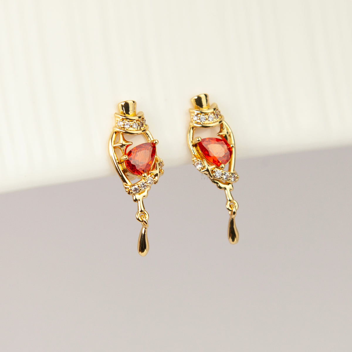 18K gold-plated royal crimson hat starburst teardrop clip-on earrings with red CZ stone and coil back non-pierced closure