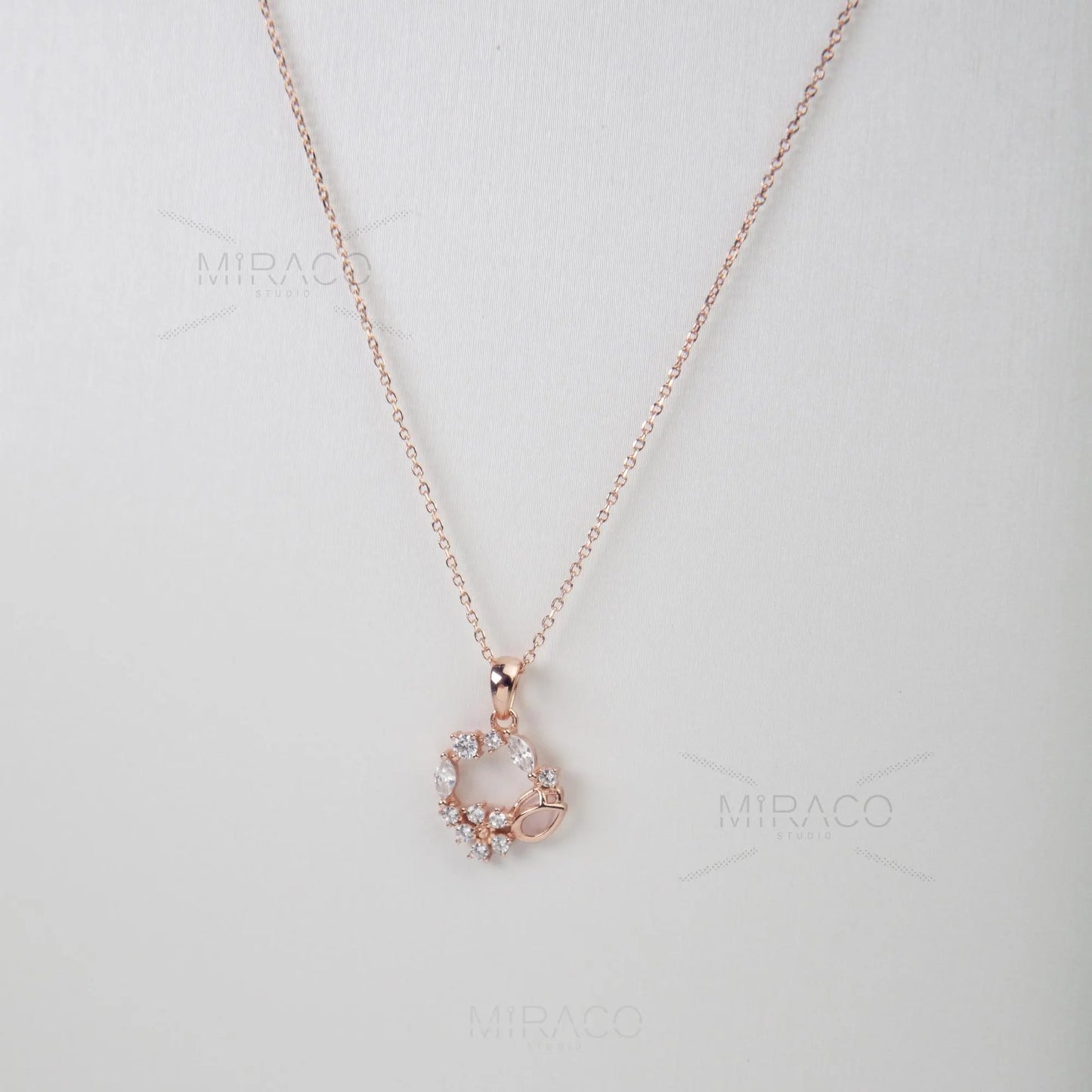 Discover enchanting elegance with our Flower Wreath Necklace. Crafted from high-quality, genuine&nbsp;925 sterling silver&nbsp;and finished with a warm&nbsp;rose gold color, this piece offers both durability and on-trend style.