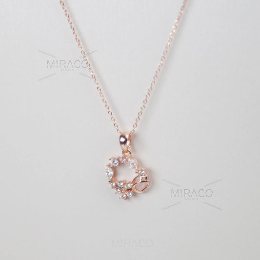 Discover enchanting elegance with our Flower Wreath Necklace. Crafted from high-quality, genuine&nbsp;925 sterling silver&nbsp;and finished with a warm&nbsp;rose gold color, this piece offers both durability and on-trend style.