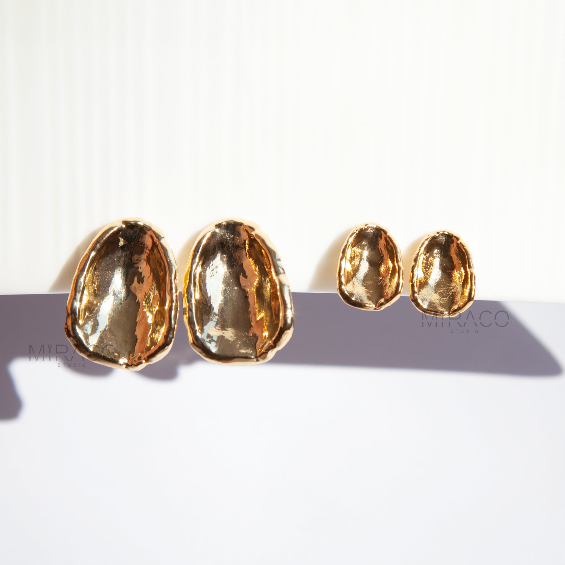 Effortless Elegance, No Piercing Needed.

Make a sophisticated statement without needing pierced ears! These stunning clip-on earrings feature a captivating, organically inspired shape with a beautifully textured surface. Finished in a radiant gold plating, they catch the light exquisitely, adding a touch of modern luxury to any look.

Designed for both style and comfort, these earrings utilize a secure screw-back clip mechanism. This allows you to adjust the tension for a perfect, personalized fit that sta