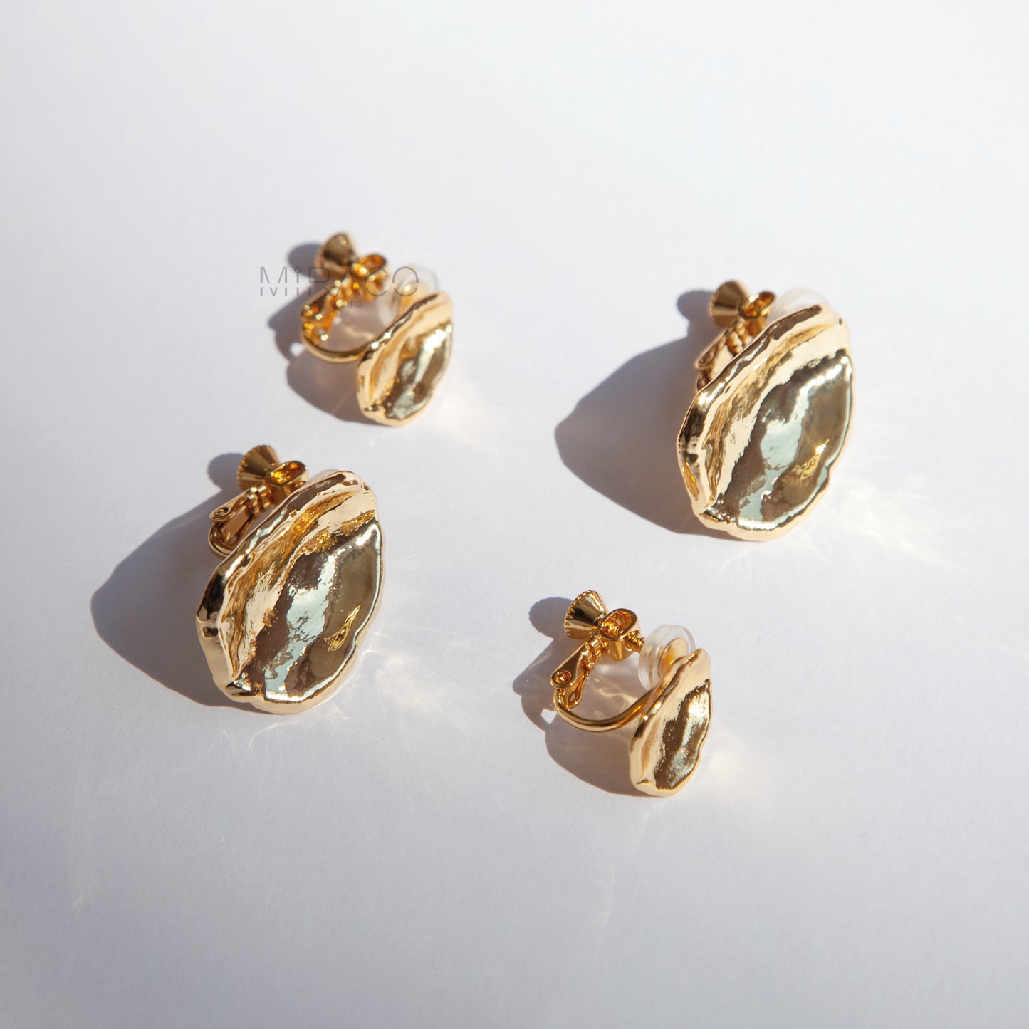 Effortless Elegance, No Piercing Needed.

Make a sophisticated statement without needing pierced ears! These stunning clip-on earrings feature a captivating, organically inspired shape with a beautifully textured surface. Finished in a radiant gold plating, they catch the light exquisitely, adding a touch of modern luxury to any look.

Designed for both style and comfort, these earrings utilize a secure screw-back clip mechanism. This allows you to adjust the tension for a perfect, personalized fit that sta
