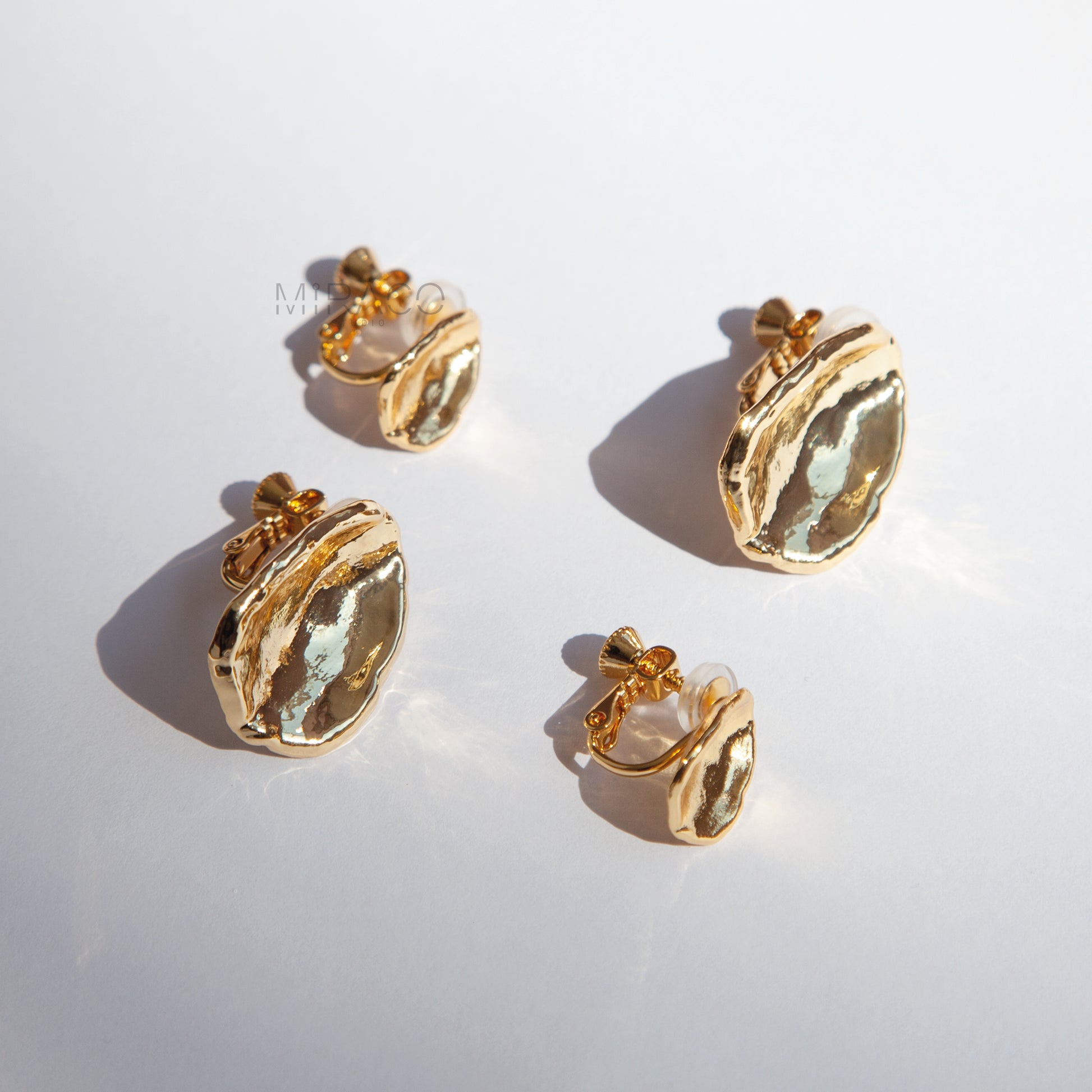 Effortless Elegance, No Piercing Needed.

Make a sophisticated statement without needing pierced ears! These stunning clip-on earrings feature a captivating, organically inspired shape with a beautifully textured surface. Finished in a radiant gold plating, they catch the light exquisitely, adding a touch of modern luxury to any look.

Designed for both style and comfort, these earrings utilize a secure screw-back clip mechanism. This allows you to adjust the tension for a perfect, personalized fit that sta