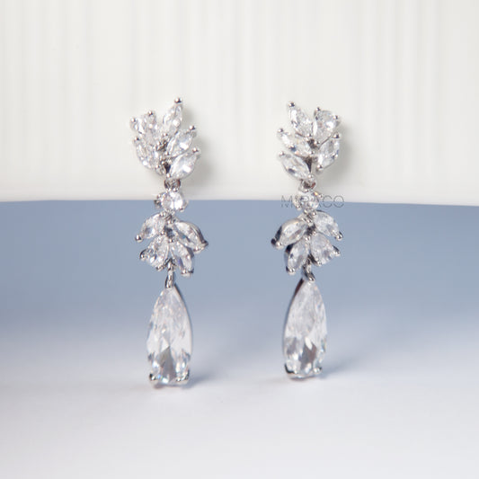 Make a Statement Without the Piercing.

Designed to dazzle, these clip-on dangle earrings feature a cascading leaf-inspired design adorned with sparkling clear cubic zirconia crystals. Long and elegant, they offer that bold, statement look — with mini-clip fastenings that stay secure without pierced ears.

Whether you’re dressing up for a wedding, evening event, or adding glamour to your everyday style, these earrings bring graceful movement and eye-catching shine.