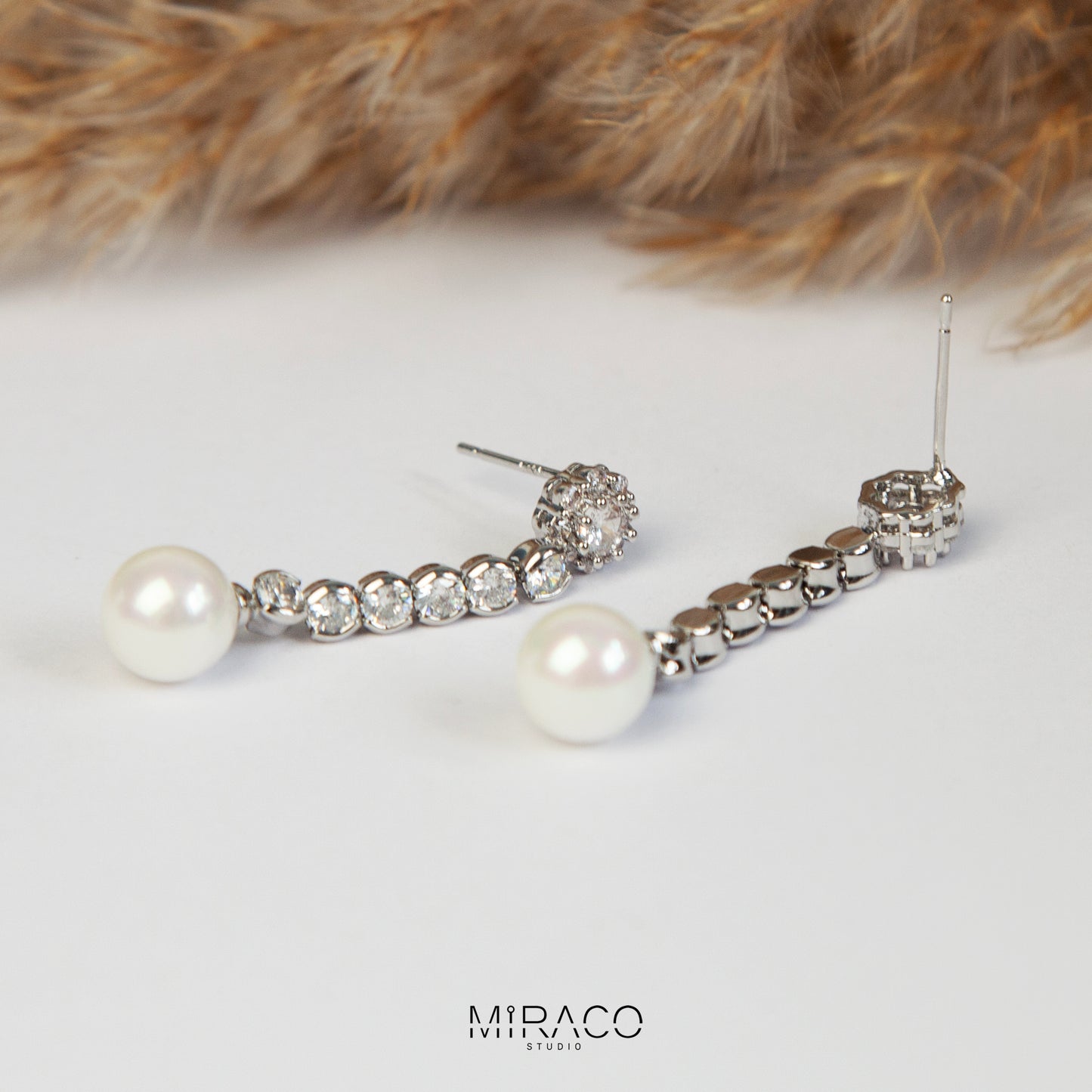 Pair of long dangle clip-on earrings with Mini-Clip back, featuring a paved CZ top and spherical pearl drop