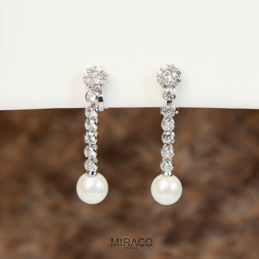 Pair of long dangle clip-on earrings with Mini-Clip back, featuring a paved CZ top and spherical pearl drop