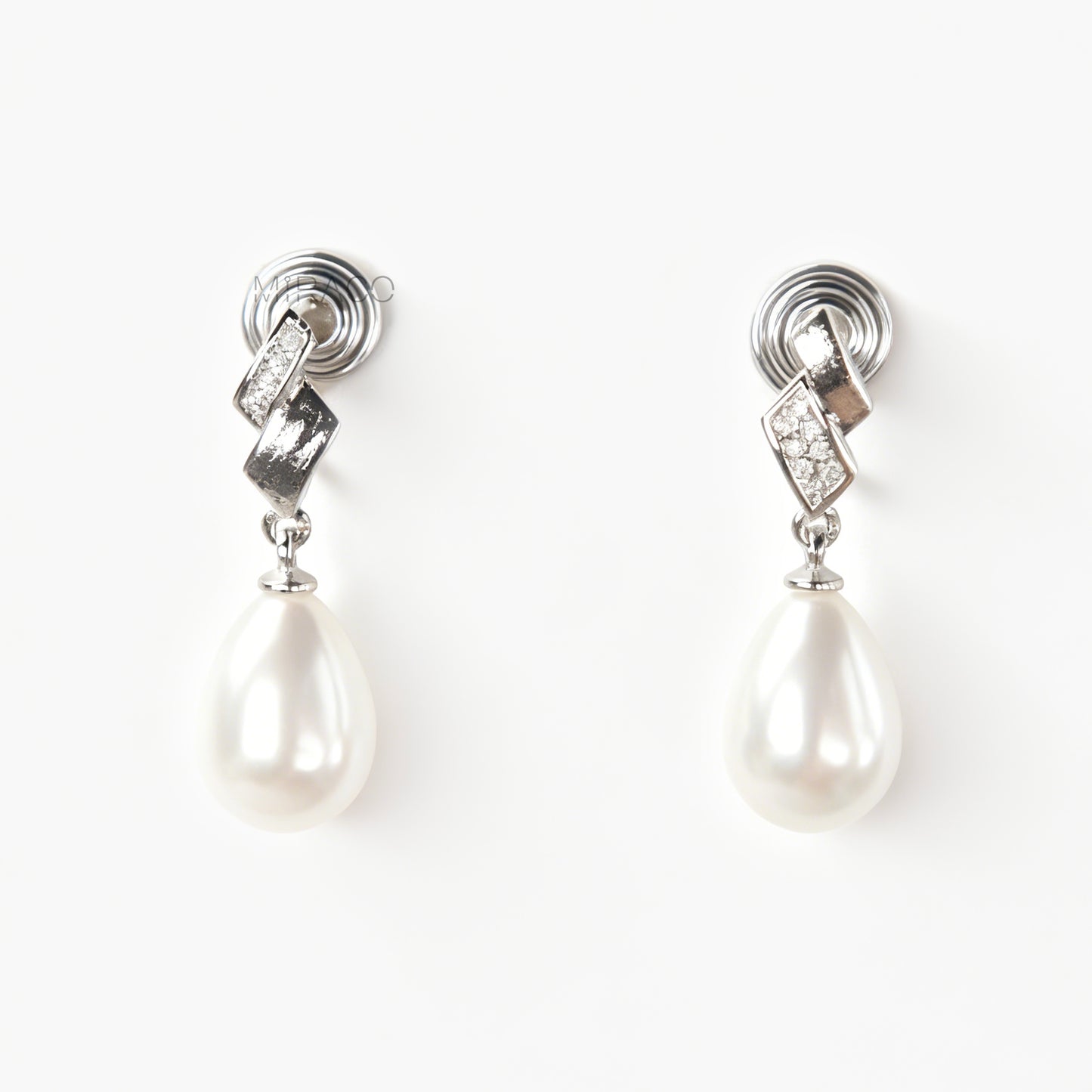 Close-up view of the comfortable coil-back clip mechanism on the gold-tone and silver-tone pearl drop clip-on earrings, showing the secure backing and rhinestone detail.