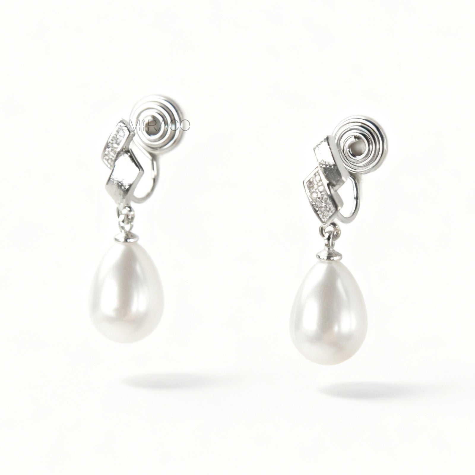 Close-up view of the comfortable coil-back clip mechanism on the gold-tone and silver-tone pearl drop clip-on earrings, showing the secure backing and rhinestone detail.