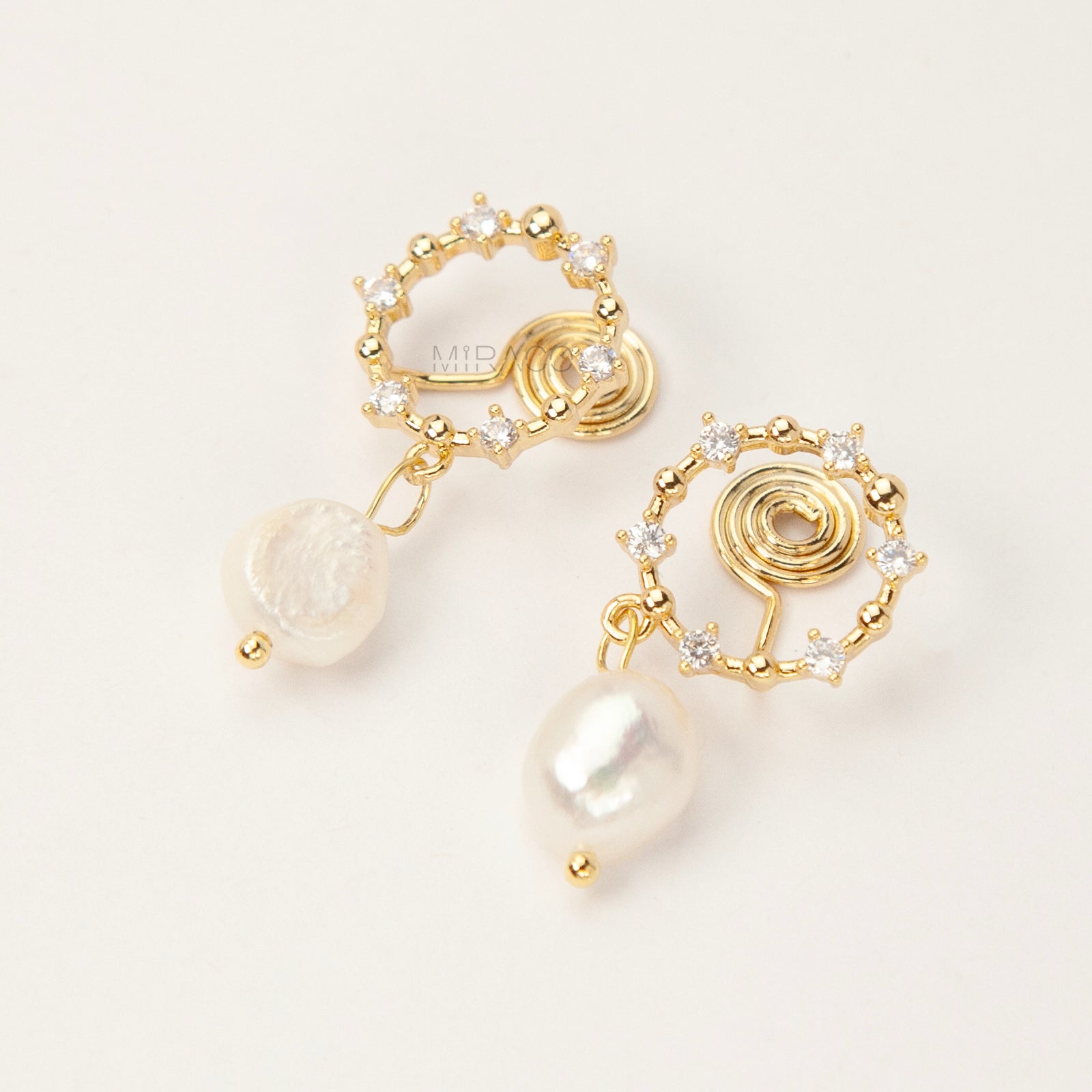 Pair of gold-plated coil back clip-on earrings featuring a wreath shape encrusted with cubic zirconia stones and a dangling white, genuine Freshwater Baroque Pearl.