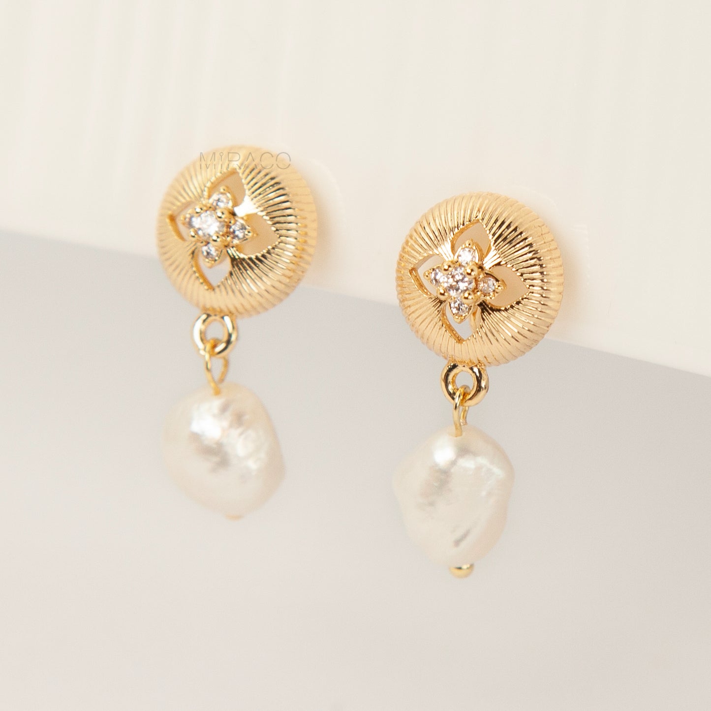 Gold plated baroque pearl dangle clip-on earrings with secure coil back closure for non-pierced ears