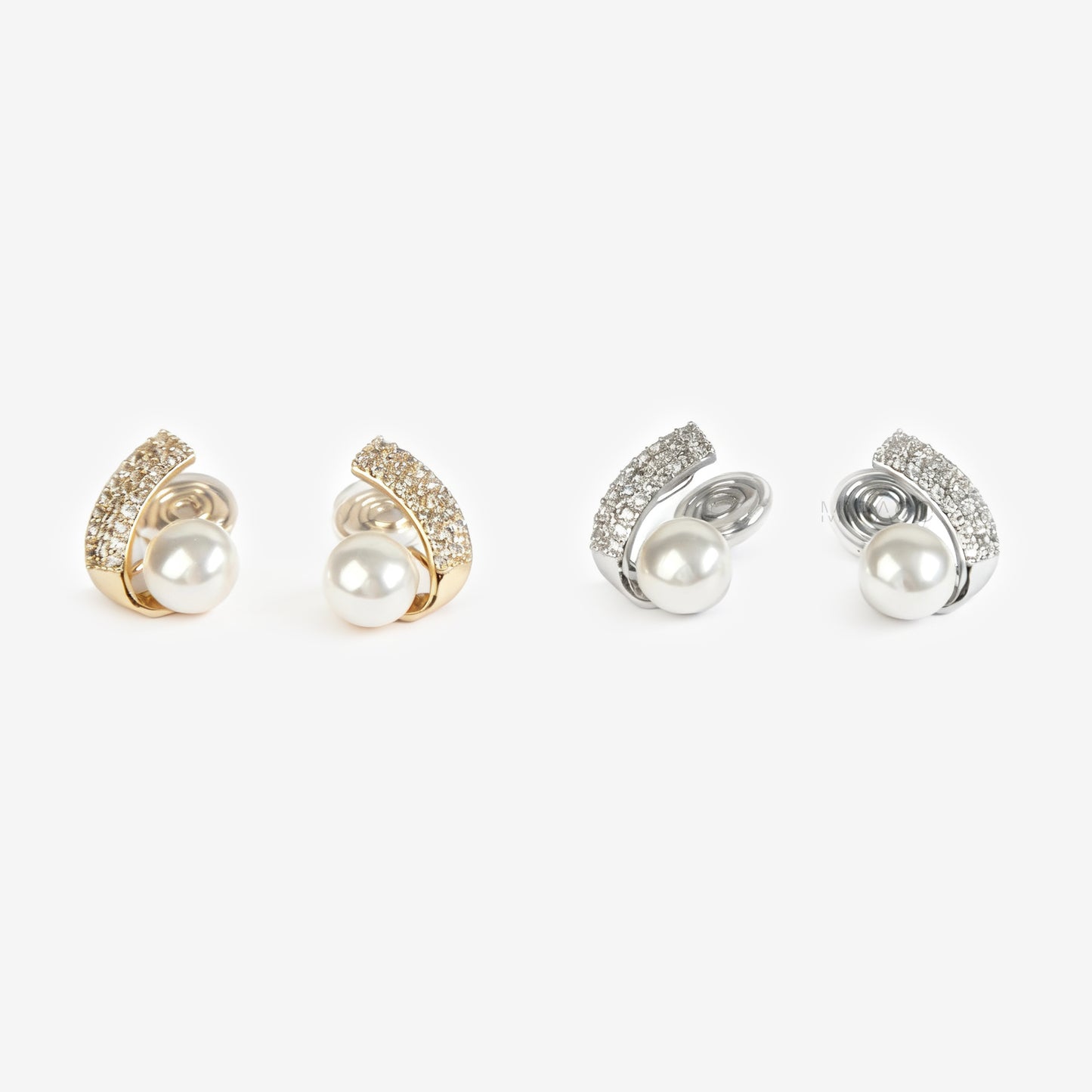 Set of four clip on pearl earrings with gold and silver accents on a white background