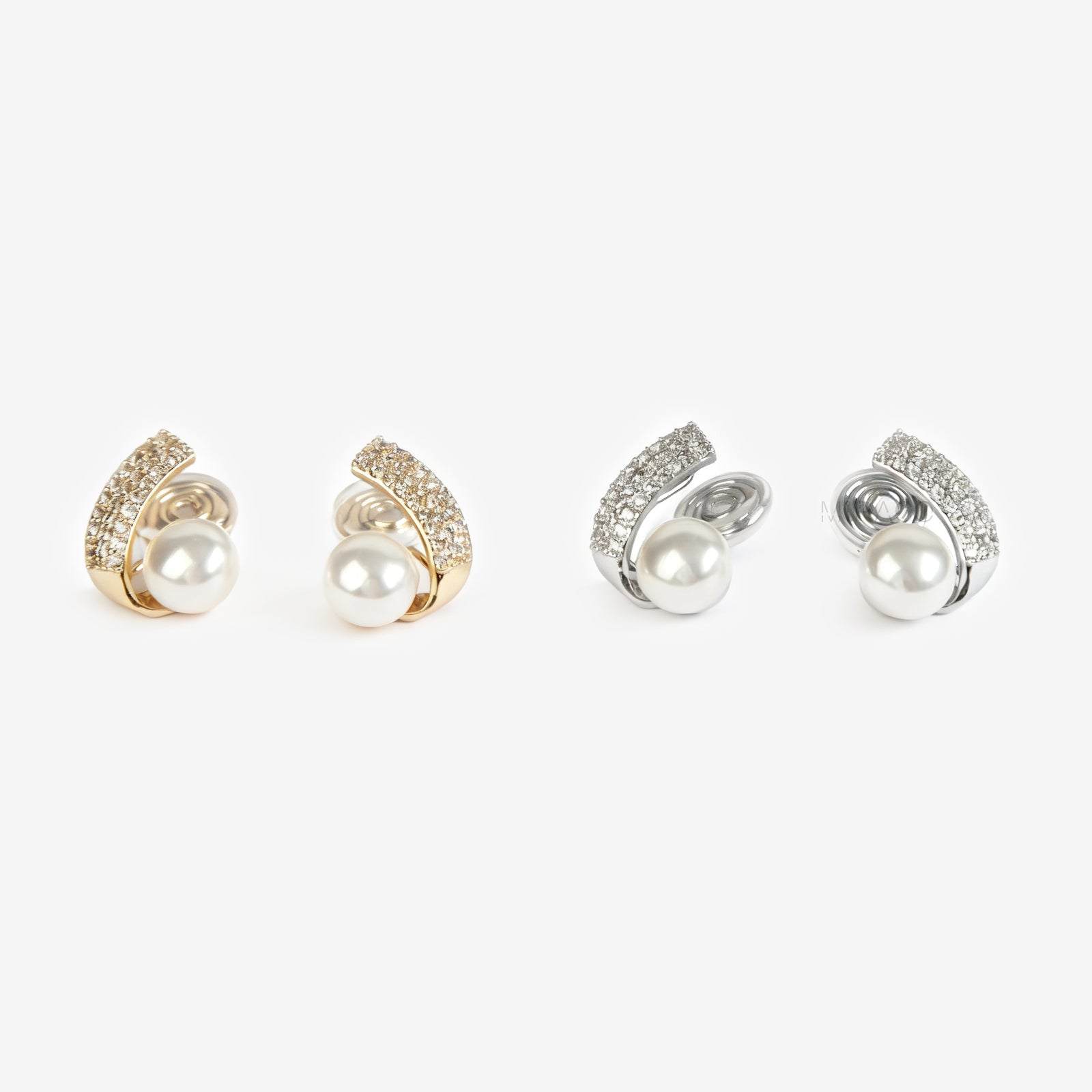 Set of four clip on pearl earrings with gold and silver accents on a white background