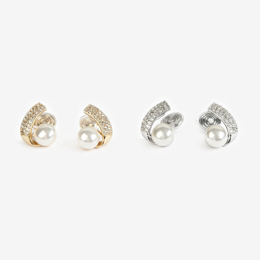 Set of four clip on pearl earrings with gold and silver accents on a white background