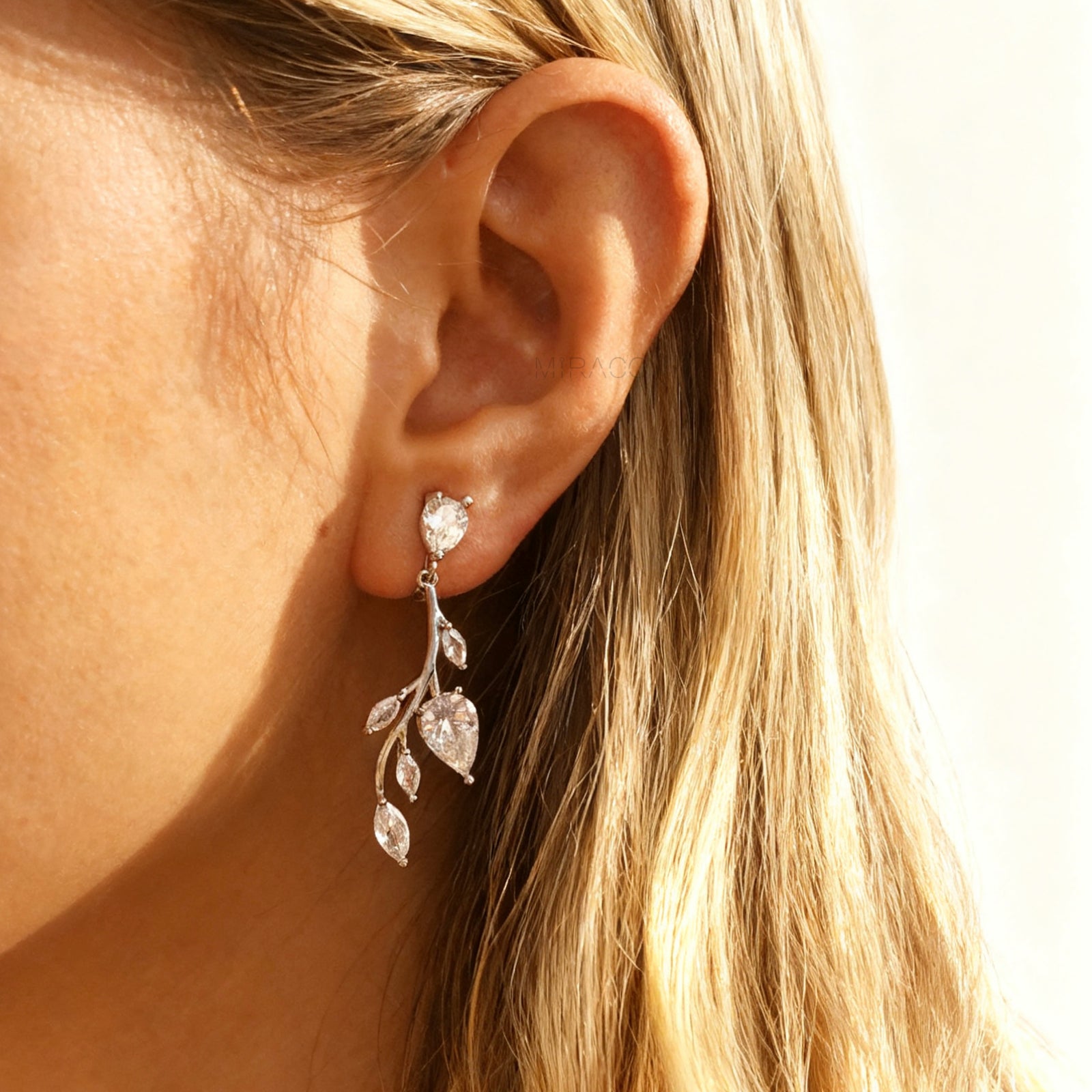 Pair of silver-tone vine leaf dangle clip-on earrings with Mini-Clip closure and sparkling Cubic Zirconia stones.
