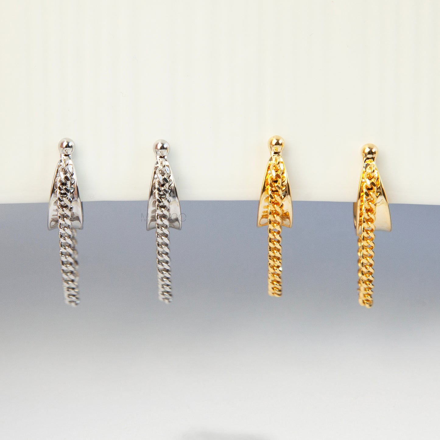 Hoop Clip-On Earrings with a Draped Chain, two in gold-tone and two in silver-tone, showing the Spring Coil Back.