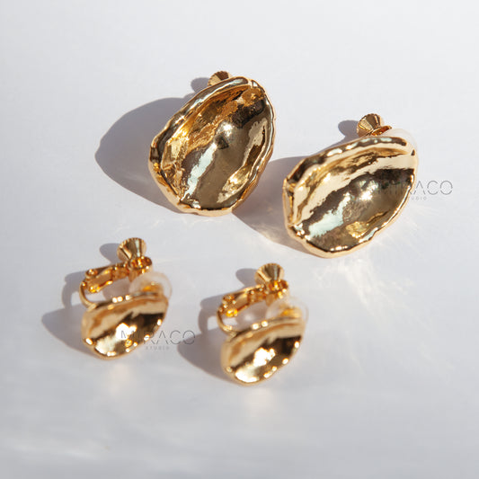 Effortless Elegance, No Piercing Needed.

Make a sophisticated statement without needing pierced ears! These stunning clip-on earrings feature a captivating, organically inspired shape with a beautifully textured surface. Finished in a radiant gold plating, they catch the light exquisitely, adding a touch of modern luxury to any look.

Designed for both style and comfort, these earrings utilize a secure screw-back clip mechanism. This allows you to adjust the tension for a perfect, personalized fit that sta