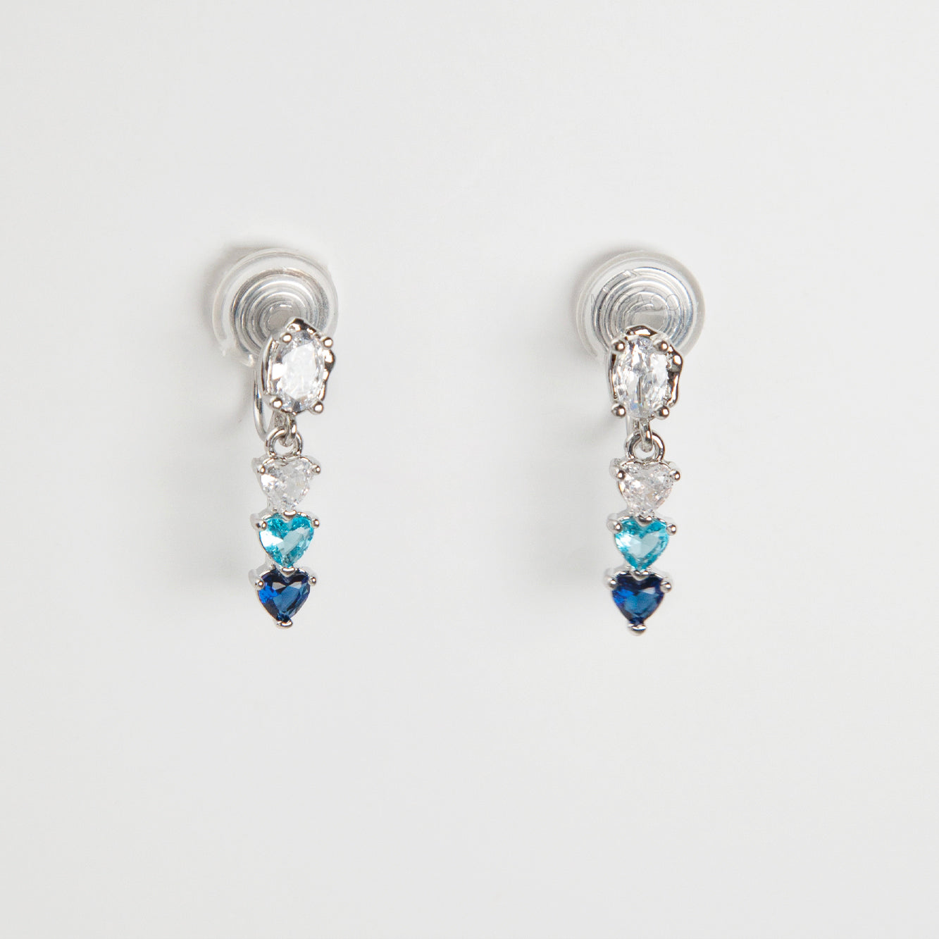 Pair of clip on earrings with heart-shaped gemstones, blue and white gem stone
