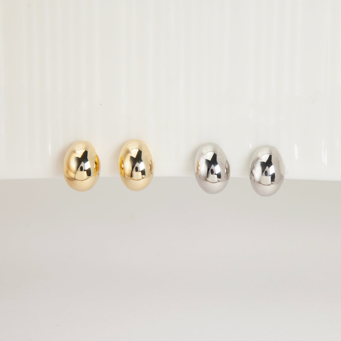 clip-on earrings, silver clip-on earrings, gold clip-on earrings, oval stud earrings, minimalist earrings, non-pierced earrings, U-shape coil clip-on, everyday stud earrings, polished oval earrings, lightweight clip-on earrings
