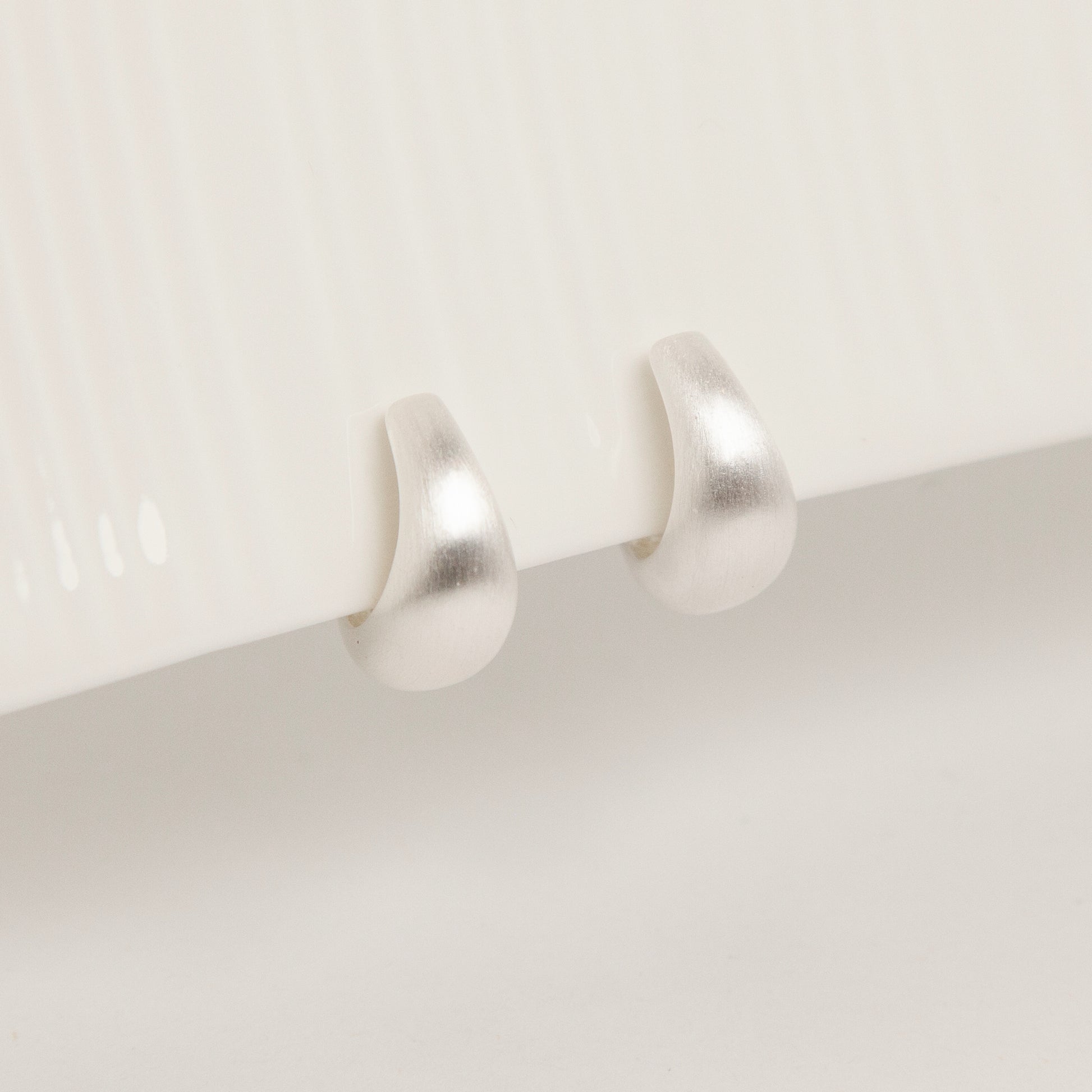 brushed silver clip-on earrings, dome hoop clip-ons, silver coil back earrings, non pierced hoop earrings, matte silver hoop earrings, clip-on everyday earrings, brushed finish earrings, classic silver dome hoops