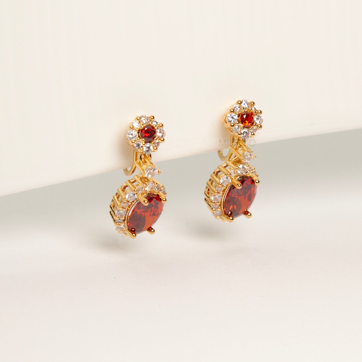 uby red clip-on earrings, ruby crystal drop earrings, red oval clip-on earrings, gold ruby clip-on earrings, ruby red dangle earrings non pierced, ruby clip-on earrings for weddings, ruby red statement earrings, ruby red ear clips, ruby red evening earrings non pierced, crystal halo clip-on earrings, ruby inspired jewellery clip ons