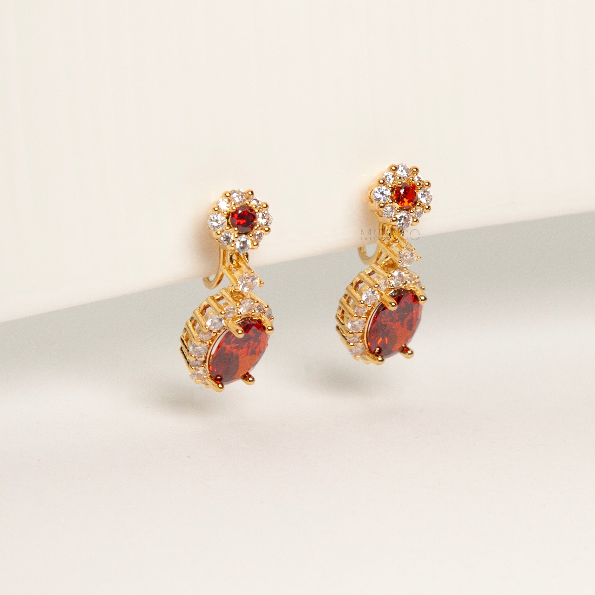 uby red clip-on earrings, ruby crystal drop earrings, red oval clip-on earrings, gold ruby clip-on earrings, ruby red dangle earrings non pierced, ruby clip-on earrings for weddings, ruby red statement earrings, ruby red ear clips, ruby red evening earrings non pierced, crystal halo clip-on earrings, ruby inspired jewellery clip ons