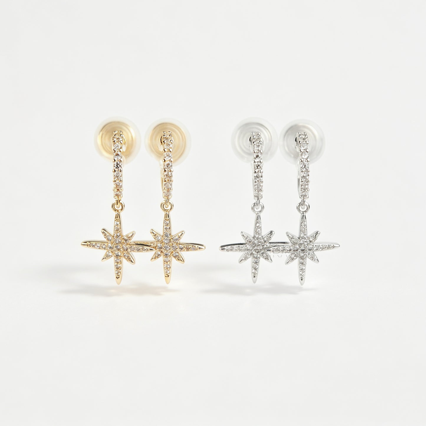 Gold and silver non-pierced clip-on dangle earrings with coil backs, featuring cubic zirconia paved hoops and celestial starburst drops.