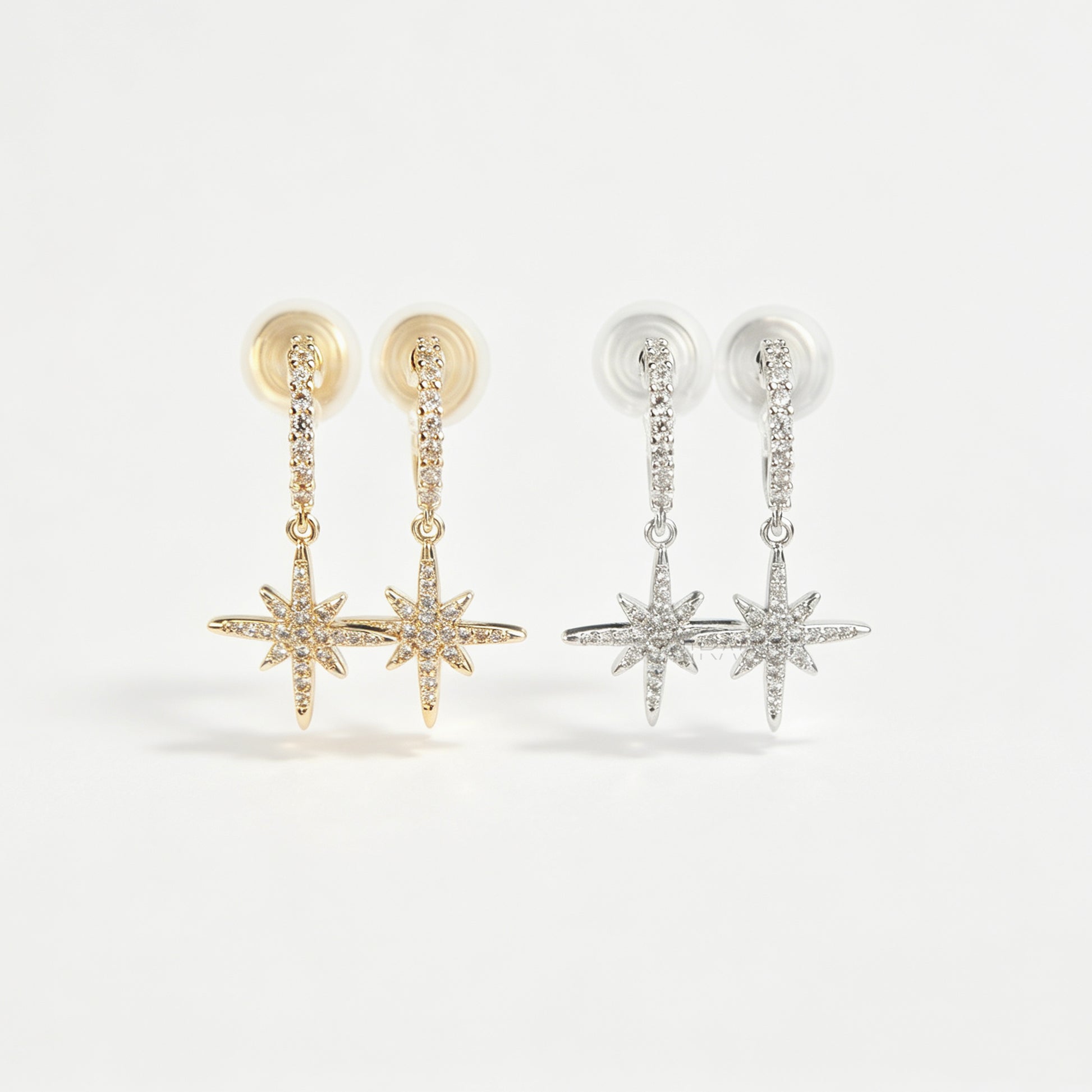 Gold and silver non-pierced clip-on dangle earrings with coil backs, featuring cubic zirconia paved hoops and celestial starburst drops.