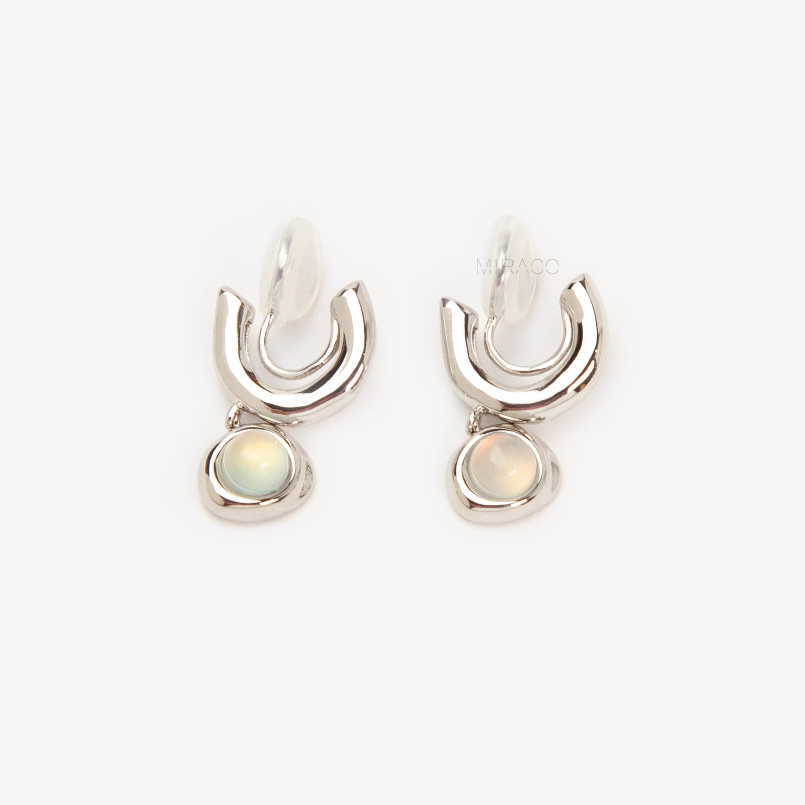 Silver opal-style clip-on earrings with curved modern design and coil-back clips for non-pierced ears.