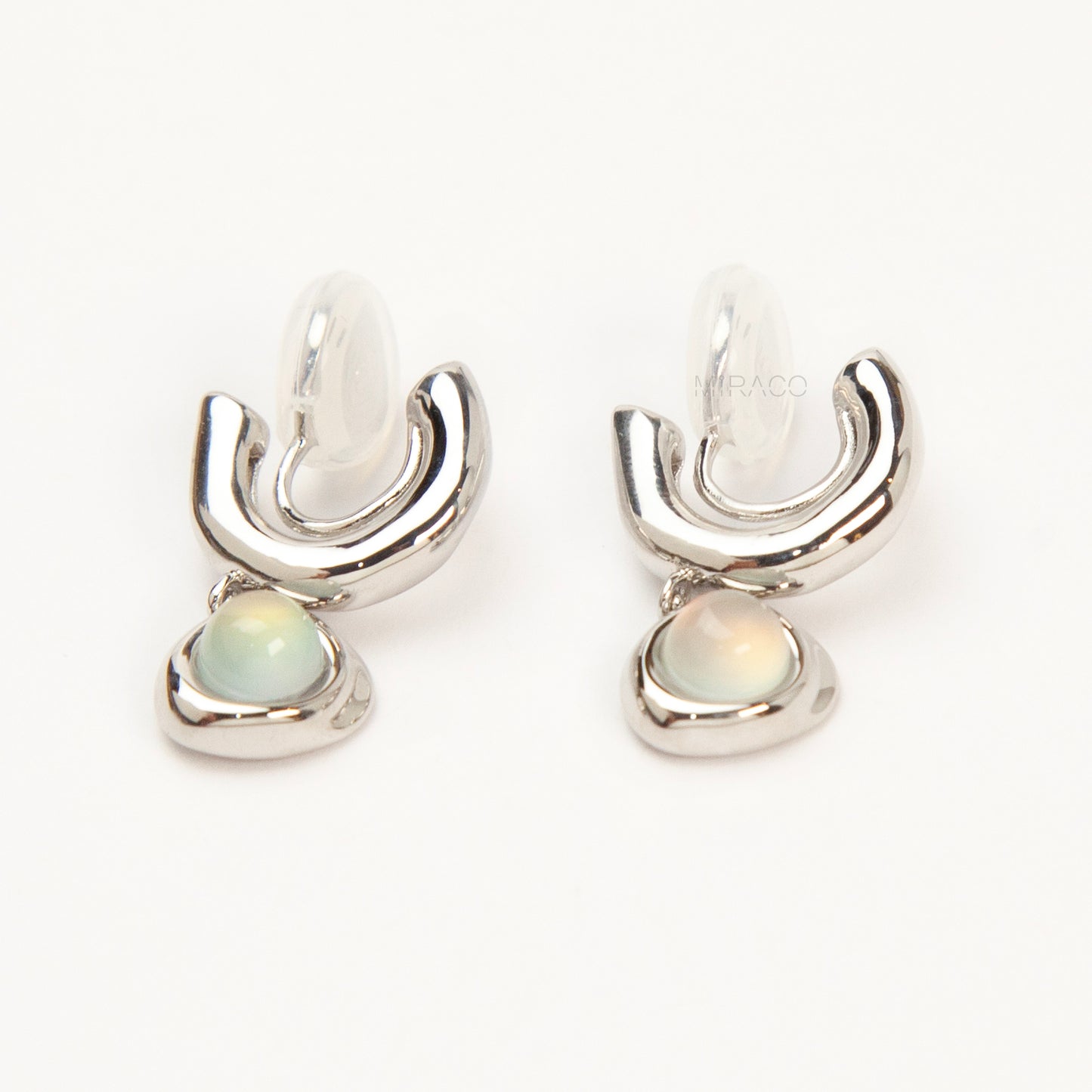 Silver opal-style clip-on earrings with curved modern design and coil-back clips for non-pierced ears.