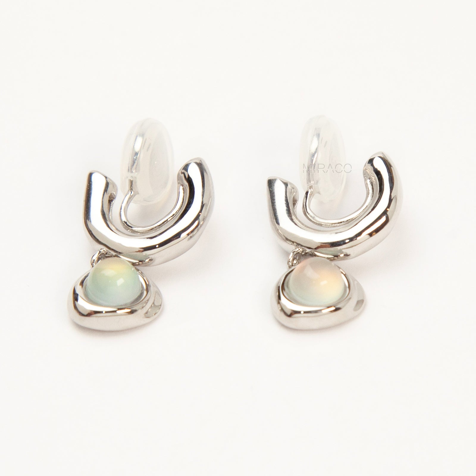 Silver opal-style clip-on earrings with curved modern design and coil-back clips for non-pierced ears.