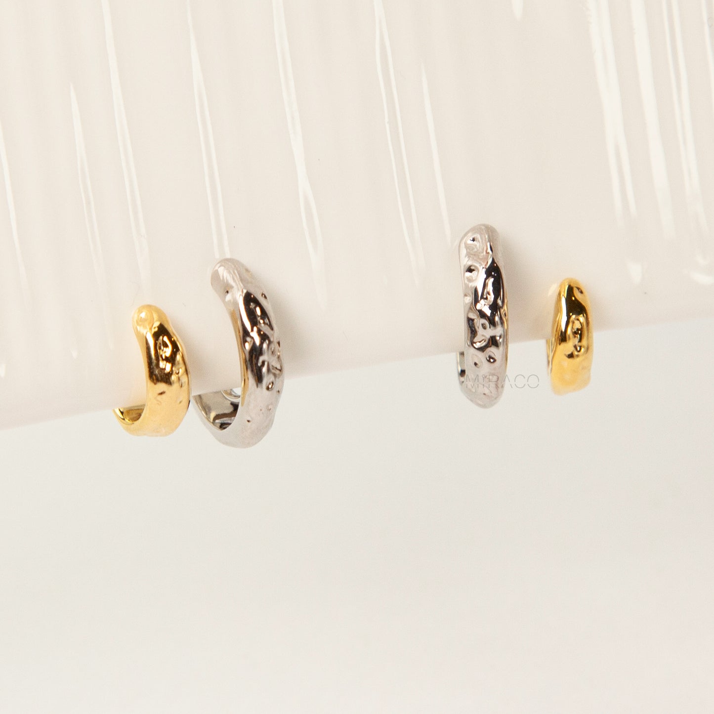 Two-tone double hoop clip-on earrings with textured silver and gold hoops, coil-back design