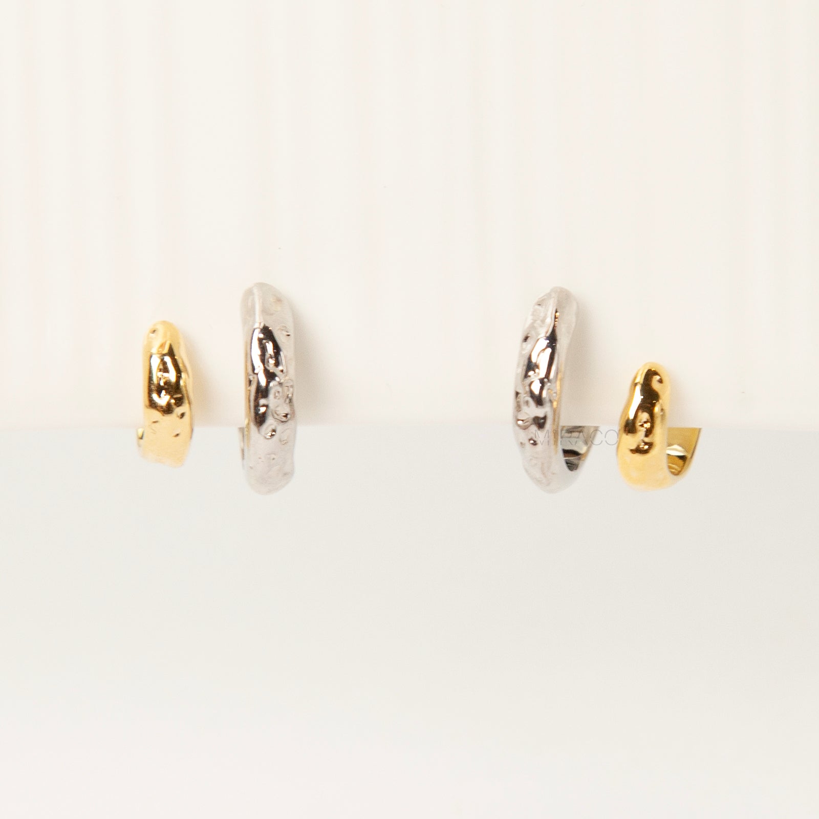 Two-tone double hoop clip-on earrings with textured silver and gold hoops, coil-back design