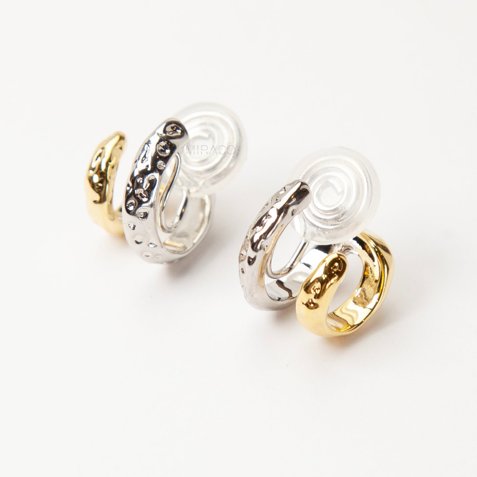 Two-tone double hoop clip-on earrings with textured silver and gold hoops, coil-back design